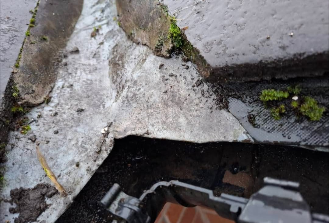 Blocked gutter being cleared